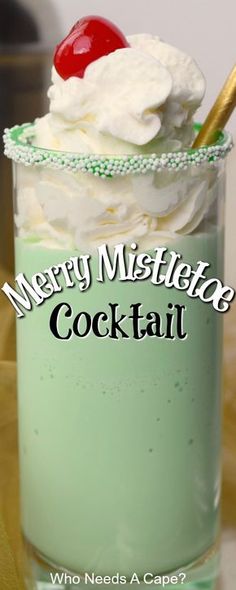 merry mistlete cocktail with whipped cream and cherries in a glass on a table