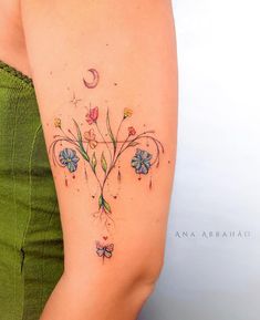 the back of a woman's arm with flowers on it