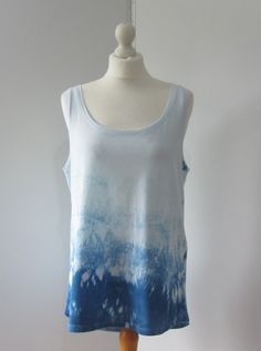 "Indigo tie-dyed organic cotton vest. Individually tie-dyed in the UK with Indigo dye. Made from light soft organic cotton. Chest/Bust 40\" / 102cm      Length 28\"/ 71cm   Back Length  30\"/ 76 cm" Sleeveless Cotton Tops With Natural Dye, Sleeveless Cotton Top With Natural Dye, Blue Washed Cotton Tank Top, Tie-dye Cotton Tank Top, Tie Dye Cotton Tank Top, Spring Tie Dye Cotton Tank Top, Summer Cotton Acid Wash Tank Top, Spring Acid Wash Cotton Tank Top, Summer Acid Wash Cotton Tank Top