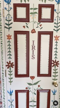 the front door is decorated with flowers and leaves, which are painted on white paper