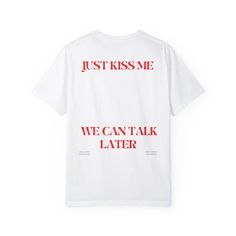 Get ready to make a statement with our cheeky "Just Kiss Me We Can Talk Later" Unisex T-shirt! Crafted with care from 100% ring-spun cotton, this lightweight fabric (4.5 oz/yd² (153 g/m feels like a bliss to wear all year round. The classic fit with the crew neckline delivers a clean, versatile style that can match any occasion, whether it's formal or semi-formal. All shirts feature a pearlized, tear-away label for total wearing comfort, ensuring that you can make your move with confidence and comfort. What's more, our tees are made using ethically grown and harvested US cotton. Gildan is also a proud member of the US Cotton Trust Protocol, ensuring ethical and sustainable means of production. This blank tee is certified by Oeko-Tex for safety and quality assurance. So why wait? Grab your Red T-shirt With Funny Text For Summer, White T-shirt With Funny Text For Streetwear, Graphic Tee With Text Print, Graphic Tee With Letter Print, Graphic Tee With Slogan And Crew Neck, White Slogan Graphic Tee T-shirt, White Graphic Tee With Slogan Print, White Print Slogan Graphic Tee, White Slogan Graphic Tee