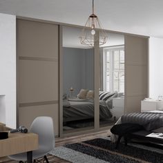 a bedroom with mirrored closet doors and a bed