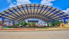 an outdoor covered parking lot with blue skies in the background