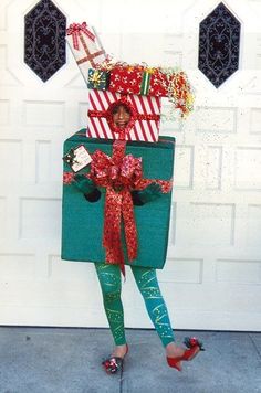 a woman standing in front of a garage door with presents on top of her head