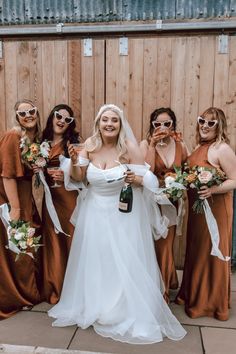 the bride and her bridesmaids pose for a photo