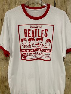 The Beatles played two shows at Detroit's "Old Red Barn", Olympia Stadium on Sunday, September 6, 1964. 29,000 screaming Motor City fans saw them play their 30 minute set. Also on the bill were The Caravelles, Tommy Roe and The Chiffons. This shirt is not 56 years old. A great gift for the music lover. New white short sleeved red ringer shirt with red graphics on the front. NWOT Ringer Shirt, Beatles Shirt, Beatles Tshirt, 6 September, Love Band, Motor City, Red Barn, Band Shirts, Red Tshirt