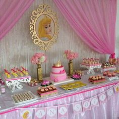 a princess themed birthday party with pink and gold decorations, desserts and cupcakes