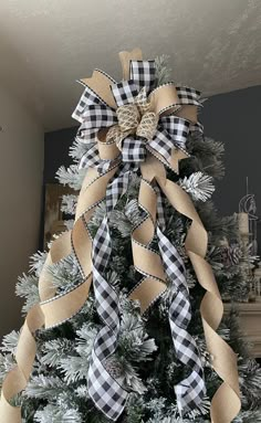 a christmas tree decorated with ribbon and bows