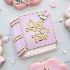 decorated cookies with the words once upon time and flowers on them are laying next to each other