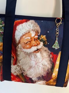 a santa clause bag hanging on the wall next to a christmas tree ornament