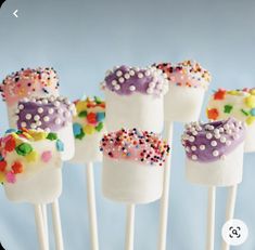 marshmallows with sprinkles are arranged on sticks