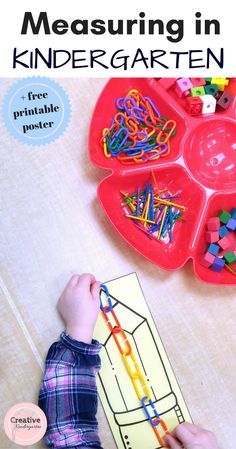 a child is making a heart shape with colored beads and construction paper on the table