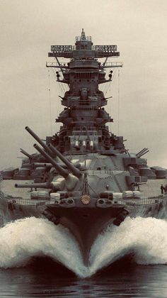 a large battleship in the middle of the ocean with water splashing around it's sides