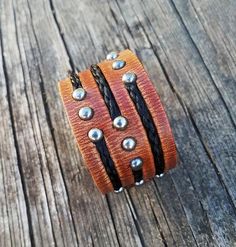 "Rockstar level quality. This cuff measures a little less than 1-1/2\" wide, and is made from hand dyed European Leather. I can customize to whatever colors you would like. Beautiful colors. Would look good on anybody looking for something unique. I can create this with your own horse's hair as a one of a kind keepsake for you treasured equine friend, or choose from a wide variety of colors in my collection. I have also included a link to a video I have made for collecting horsehair. http://www. Mane Hair, Horse Hair Bracelet, Horse Hair Jewelry, Hair Bracelet, Bracelets With Meaning, Leather Cuff Bracelet, Leather Cuffs Bracelet, Horse Hair, Beads And Wire