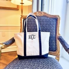 a white and blue bag sitting on top of a chair