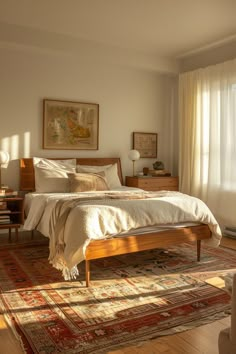 a bedroom with a bed, dresser and rug on the floor in front of a window