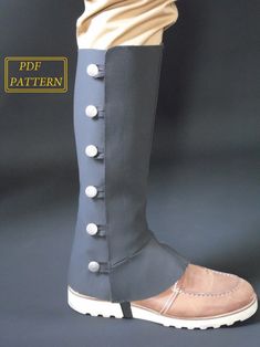 a pair of boots with buttons on the side and one in grey, white and tan