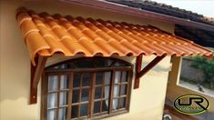 an orange tiled roof and window on a house