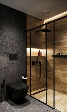 a modern bathroom with wooden walls and flooring, including a black toilet in the corner