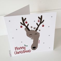 a christmas card with a reindeer's head on it