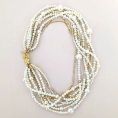 This chunky pearl necklace will be perfect for a wedding gown or long after to wear as a statement piece. I designed the necklace in bohemian elegance. The subtle color tone of the necklace will help you wear it from white to any color outfit, and the sparkles also will be enough for your wedding day or any daily events. DETAILS●Handmade in my studio● Ivory, white, cream, and a couple of golden brown color glass pearls, crystals, and rhinestone chains● Finished off a silver heart toggle, gold fi Elegant White Beaded Necklace With Chain, Elegant Multi-strand Beaded Chain Necklace, Elegant Pearl Necklace With Round Beads And Chain, Wedding Long Baroque Pearl Necklace, Elegant Multi-strand Pearl Embellished Necklaces, Bohemian Pearl Necklace For Party, Elegant Beaded Chain Pearl Necklace For Wedding, Chic Beaded Necklace For Wedding, Elegant Pearl Necklace With Chain For Wedding