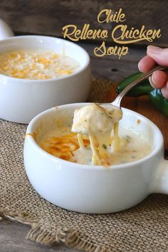 a person is spooning some food out of a white bowl with cheese on top