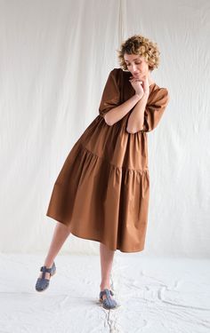 "Puff sleeve cotton dress in chocolate color. Simply and easy to wear, perfect for any occasion or to wear every day. - Handmade in our studio from 97% cotton, 3% spandex - Relaxed top with a flowy tiered skirt - Puffy elbow-length sleeves - Hidden zipper at the back - Side seam pockets FABRIC&CARE 97% cotton, 3% spandex Wash 30oC, line dry, do not tumble dry or bleach. SIZE&FIT Simona is wearing XS size and is 172 cm/5'8\" tall. SIZE XXS *BODY: Bust: fits bust around 32\"-33\"/ 82-84 cm Balloon Sleeve Dress, Tiered Skirts, Empire Dress, Chocolate Color, Apron Dress, Tier Skirt, Elbow Length Sleeve, Tiered Skirt, Dress Clothes For Women