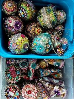 a blue container filled with lots of different colored balls