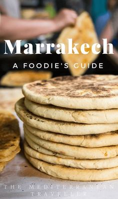 a stack of flatbreads sitting on top of a table next to some bread