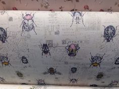 an upholstered fabric with bugs on it and writing all over the back side