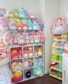 a room filled with lots of stuffed animals next to a shelf full of other stuffed animals