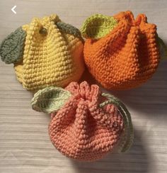 three crocheted bags sitting on top of a table