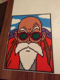 a cross stitch picture of an old man wearing sunglasses