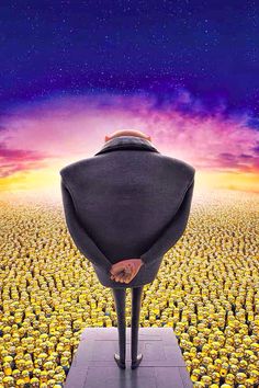 a man standing in front of a large group of yellow birds with their backs turned to the camera