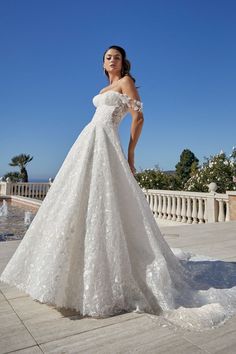 a woman in a white wedding dress posing for the camera