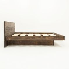 a bed frame made out of wood with no headboard or foot board on it