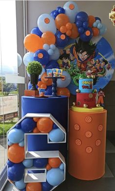 balloons and decorations are on display in front of a window at a dragon ball birthday party