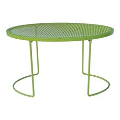 a green table with metal legs and a circular top