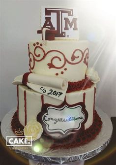 a three tiered cake is decorated with red and white icing