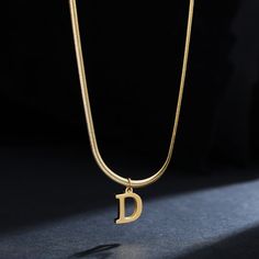 Let your style shine with this A-Z Alphabet Gold Plated Stainless Steel Pendant Necklace! Crafted of durable gold-plated stainless steel for a lasting shine, this stylish necklace will have you looking like a timeless fashionista. Make a statement today. Minimalist Gold Stainless Steel Name Necklace, Gold Metal Initial Pendant Necklace, Gold Metal Pendant Initial Necklace, Gold Minimalist Initial Necklace In Stainless Steel, Modern Gold Initial Pendant Necklace, Minimalist Gold Stainless Steel Initial Necklace, Modern Gold Stainless Steel Necklace, Trendy Gold Metal Name Necklace, Trendy Gold Name Necklace With Clavicle Chain