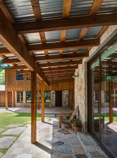 an outdoor covered patio with stone and wood