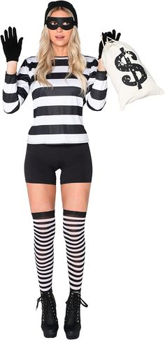 a woman dressed as a mime holding a pillow and wearing a black and white striped outfit