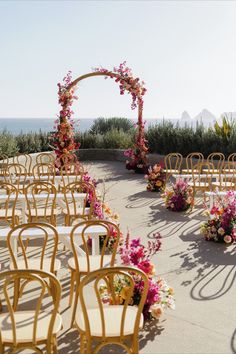 an outdoor ceremony set up with chairs and flowers