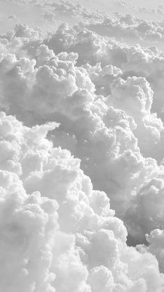 the view from an airplane window looking down on some fluffy white clouds in the sky