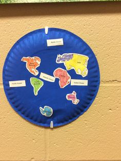 a paper plate that has different animals on it and labeled with words in the middle