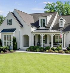 a white house with an american flag in the front yard