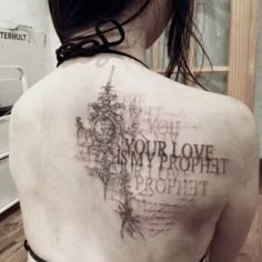 the back of a woman's shoulder with words on it