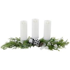 three white candles sitting next to each other with evergreen and plaid decorations on the top