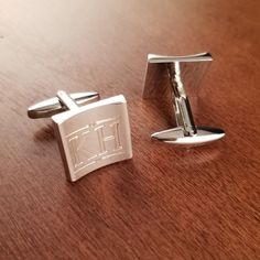 "Silver Crescent Stainless Steel Designer Cuff Links Engraved for Free. We will custom engrave each pair of these Cufflinks with initials or a monogram. Please specify what combination of letters or numbers you would like to appear on your cufflinks. We can engrave initials or monograms on these cuff links. The traditional monogram initials are: First Name Initial - Last Name Initial - Middle Name Initial. The last name in the middle is larger the the first and middle name to the left and right. Elegant Jewelry With Engraved Logo For Gift, Elegant Silver Jewelry With Engraved Logo, Formal Engraved Cufflinks, Classic Formal Jewelry With Engraved Logo, Modern Jewelry With Engraved Logo For Gift, Modern Jewelry With Engraved Logo As Gift, Classic Engraved Cufflinks, Classic Personalized Adjustable Cufflinks, Classic Personalized Cuff Jewelry