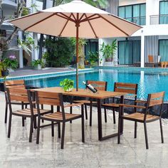 an outdoor dining table and chairs next to a swimming pool